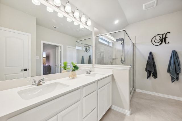 bathroom with vanity, tile patterned floors, and a shower with shower door