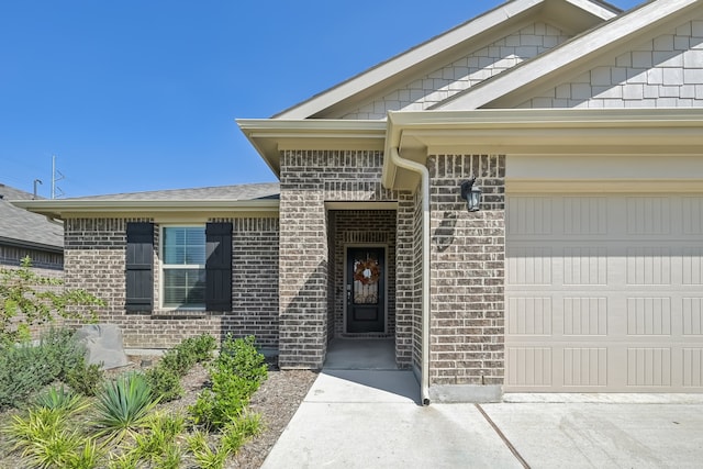 view of exterior entry with a garage