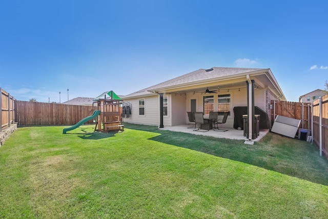 rear view of house with a yard, a playground, and a patio