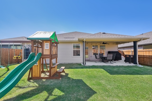 view of play area with a patio area, ceiling fan, and a yard