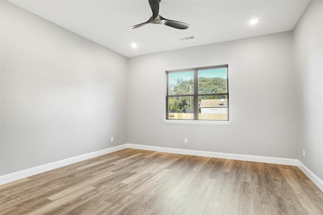 spare room with ceiling fan and light wood-type flooring