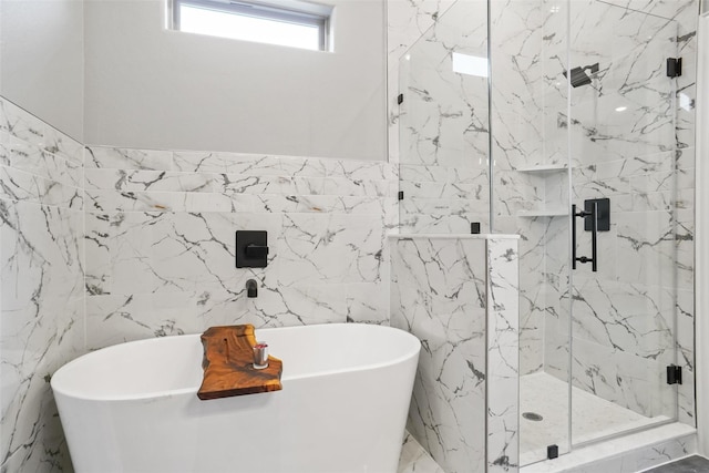 bathroom featuring plus walk in shower and tile walls