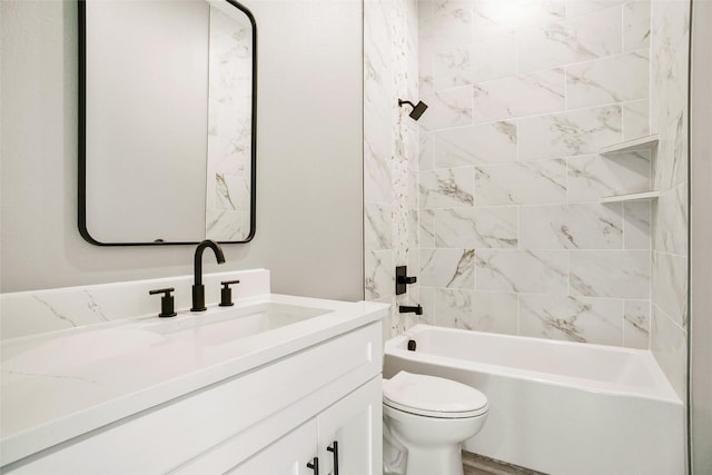 full bathroom featuring vanity, toilet, and tiled shower / bath