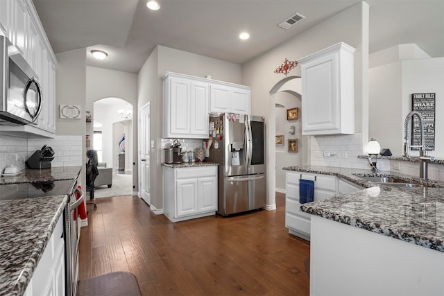 kitchen featuring backsplash, white cabinets, sink, dark hardwood / wood-style floors, and stainless steel appliances