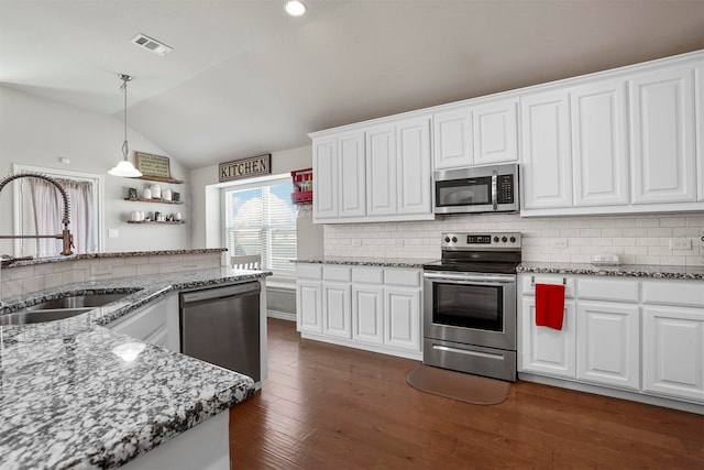 kitchen with white cabinetry, dark hardwood / wood-style flooring, stainless steel appliances, and lofted ceiling