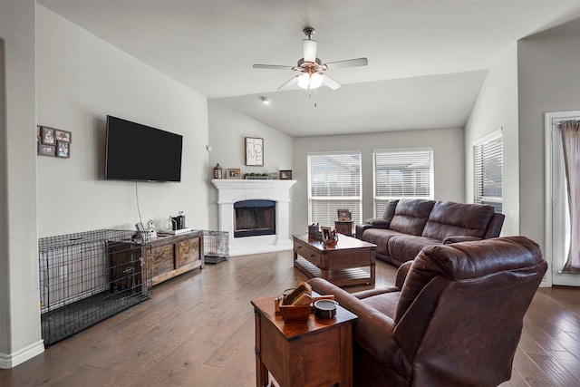 living room featuring dark hardwood / wood-style flooring, ceiling fan, and lofted ceiling