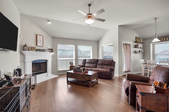 living room featuring hardwood / wood-style floors, vaulted ceiling, and ceiling fan