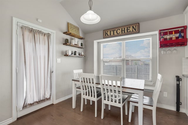 dining room with dark hardwood / wood-style floors and vaulted ceiling