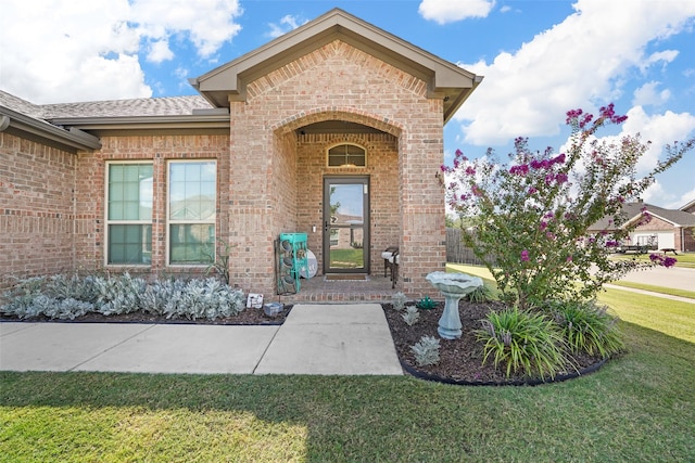 entrance to property with a lawn