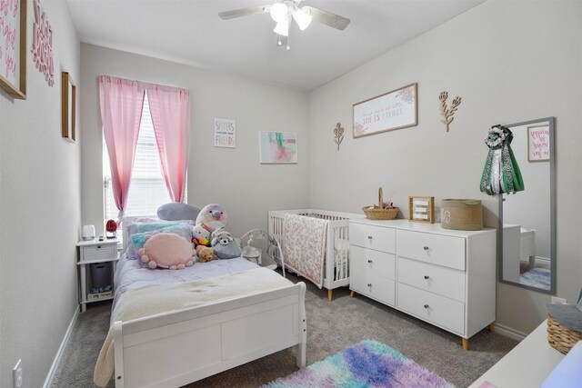 bedroom with ceiling fan and dark carpet