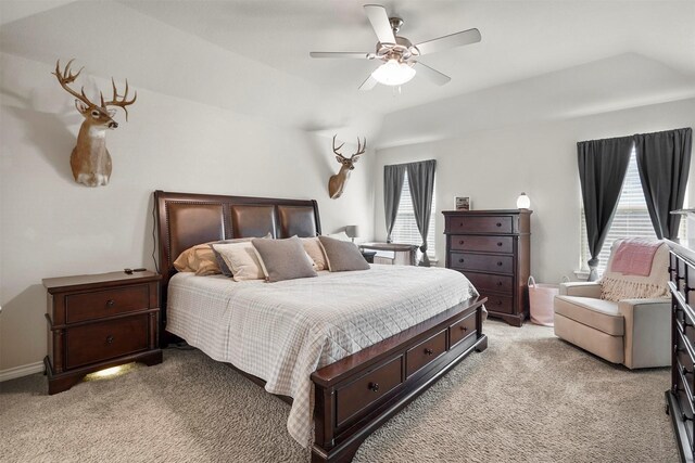 bedroom featuring ceiling fan, light carpet, and multiple windows