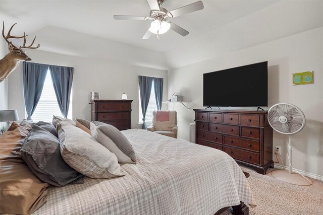 bedroom with multiple windows, ceiling fan, light carpet, and vaulted ceiling