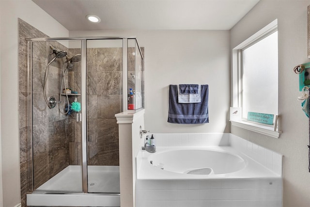 bathroom with independent shower and bath and a wealth of natural light