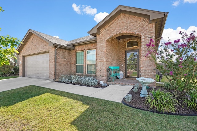 view of front of house with a front yard and a garage