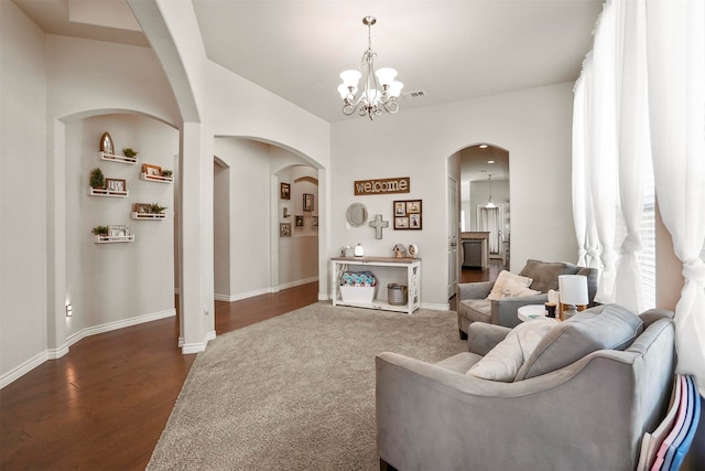 living room featuring dark hardwood / wood-style flooring and a chandelier