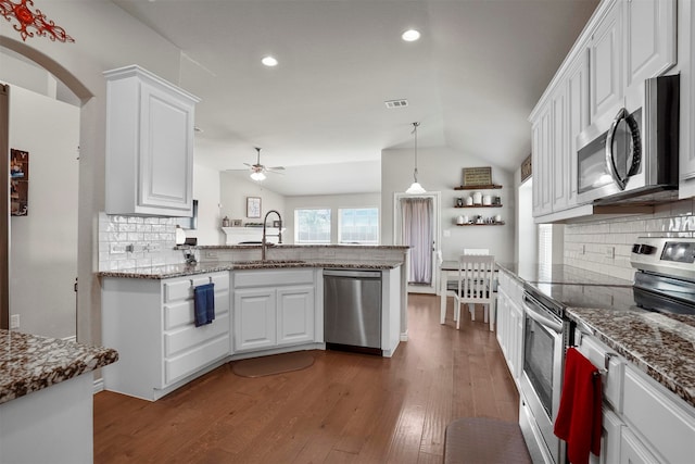 kitchen featuring sink, white cabinets, lofted ceiling, and appliances with stainless steel finishes