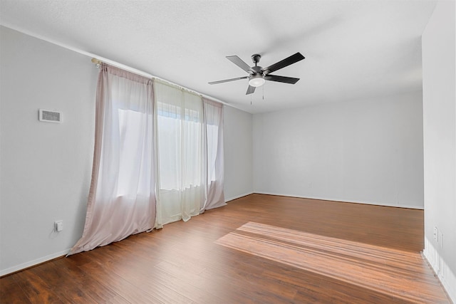 empty room with hardwood / wood-style floors and ceiling fan