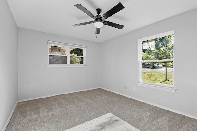 spare room with carpet floors and ceiling fan