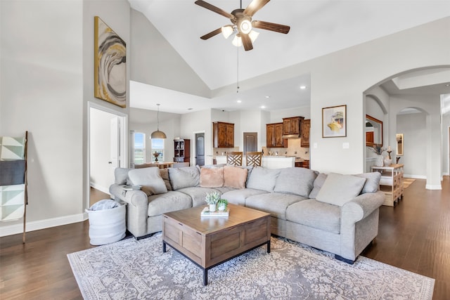 living room featuring hardwood / wood-style flooring, high vaulted ceiling, and ceiling fan