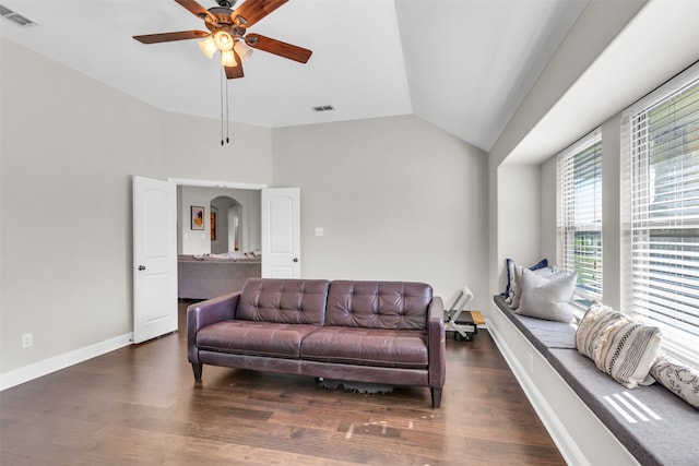 living room with vaulted ceiling, dark wood-type flooring, and ceiling fan