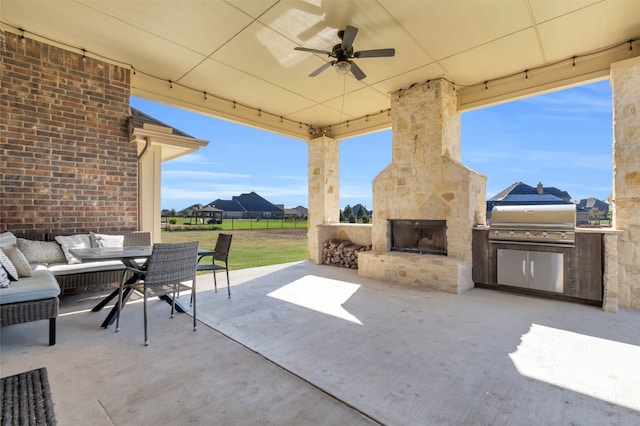 view of patio / terrace featuring ceiling fan, grilling area, an outdoor living space with a fireplace, and area for grilling