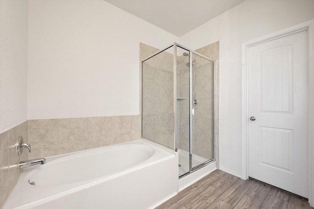 bathroom with separate shower and tub and wood-type flooring