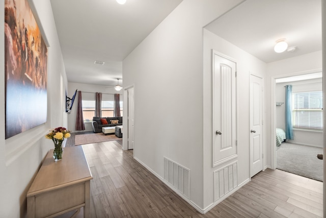 corridor featuring wood-type flooring