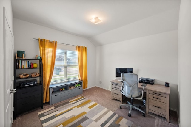 carpeted office featuring lofted ceiling