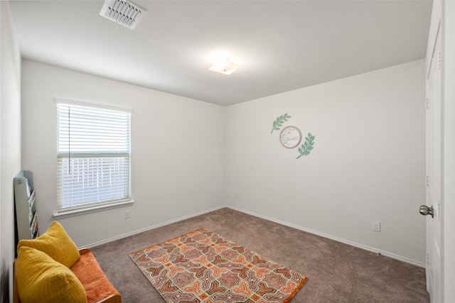 living area with dark colored carpet