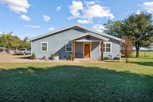 view of front of home with covered porch and a front lawn