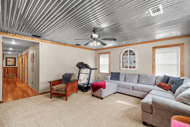 living room with ceiling fan, ornamental molding, and hardwood / wood-style flooring