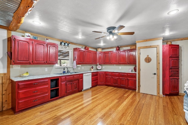 kitchen with dishwasher, sink, light hardwood / wood-style flooring, ceiling fan, and beamed ceiling