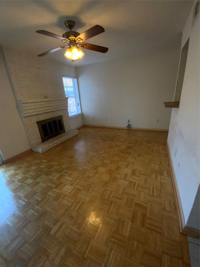 unfurnished living room featuring ceiling fan and light parquet flooring