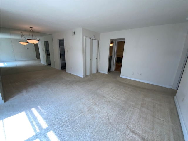 spare room with light colored carpet