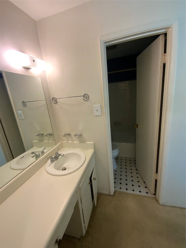 bathroom featuring tile patterned flooring, vanity, and toilet