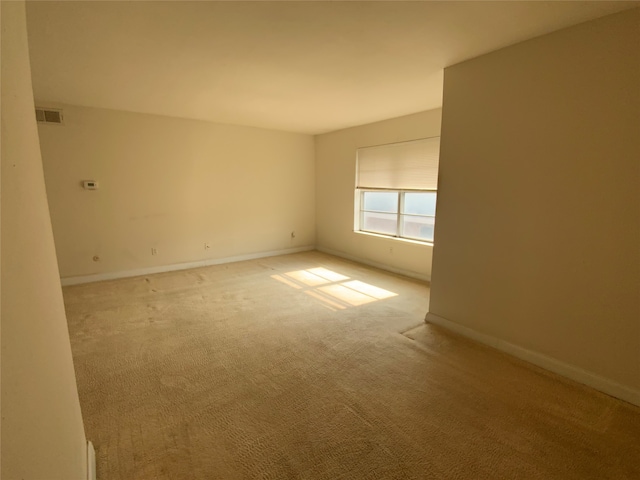 empty room featuring light carpet