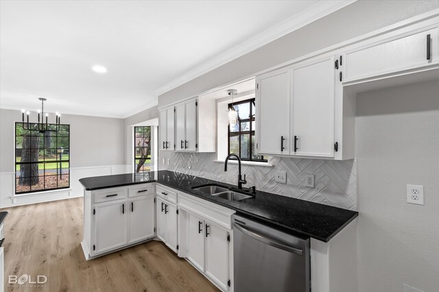 kitchen featuring dishwasher, white cabinetry, plenty of natural light, and sink