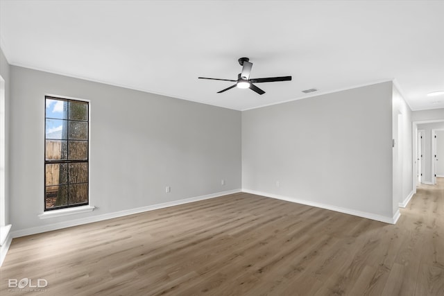 spare room featuring ceiling fan, crown molding, and light wood-type flooring