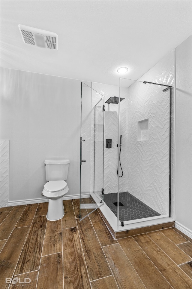 bathroom featuring toilet and walk in shower