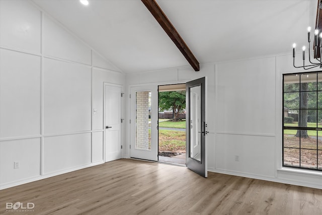 foyer with a chandelier, a wealth of natural light, beamed ceiling, and light hardwood / wood-style floors