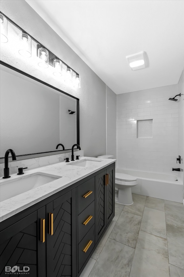 full bathroom featuring vanity, toilet, and tiled shower / bath combo