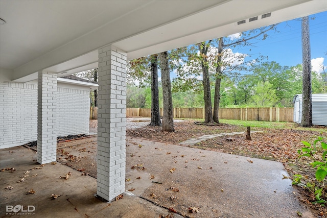 view of patio / terrace featuring a storage unit