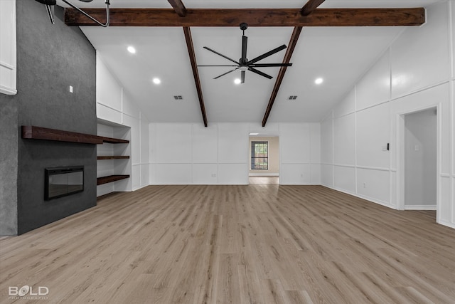 unfurnished living room featuring ceiling fan, light hardwood / wood-style floors, and beam ceiling