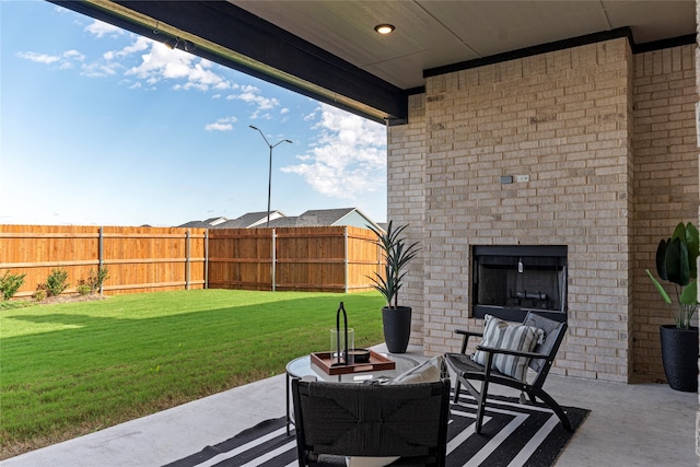 view of patio featuring an outdoor brick fireplace