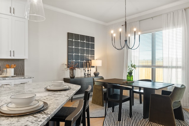 dining area featuring a chandelier, crown molding, and light hardwood / wood-style floors