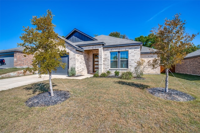 view of front of house with a front yard and a garage