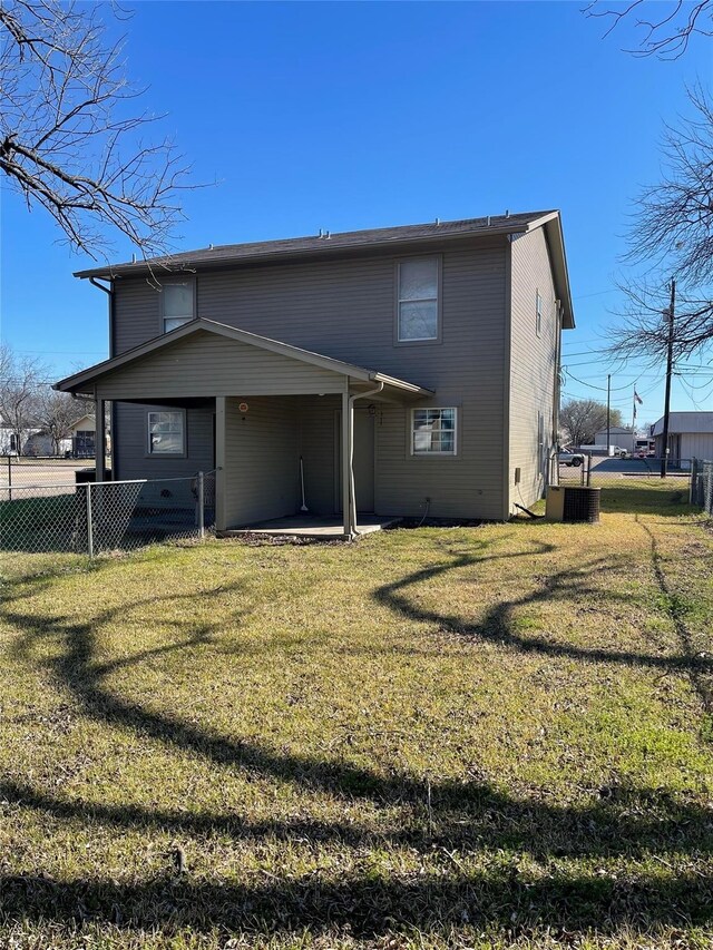 back of house featuring a yard