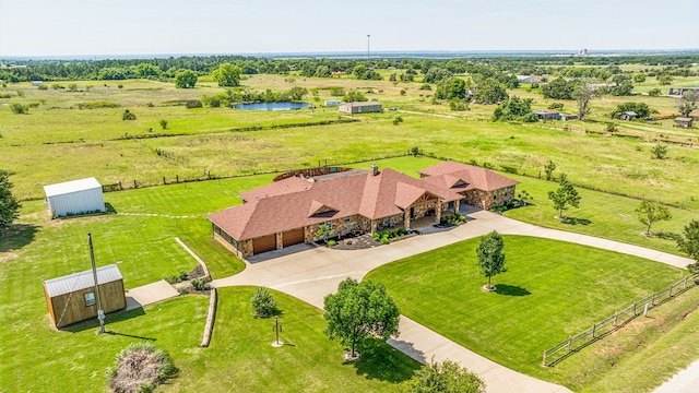 drone / aerial view featuring a water view and a rural view