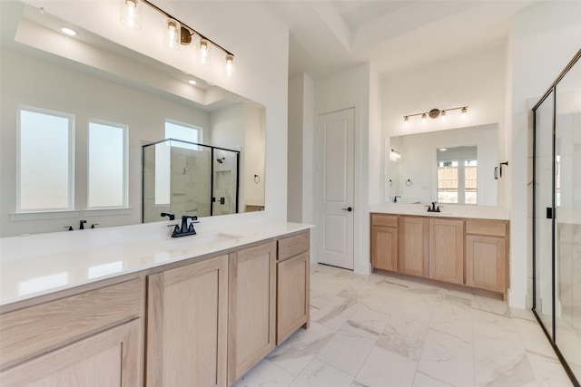 bathroom with vanity and a shower with door