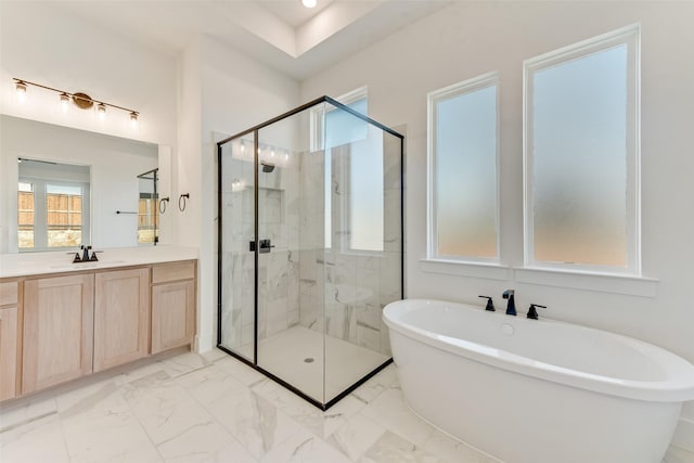 bathroom with vanity and shower with separate bathtub